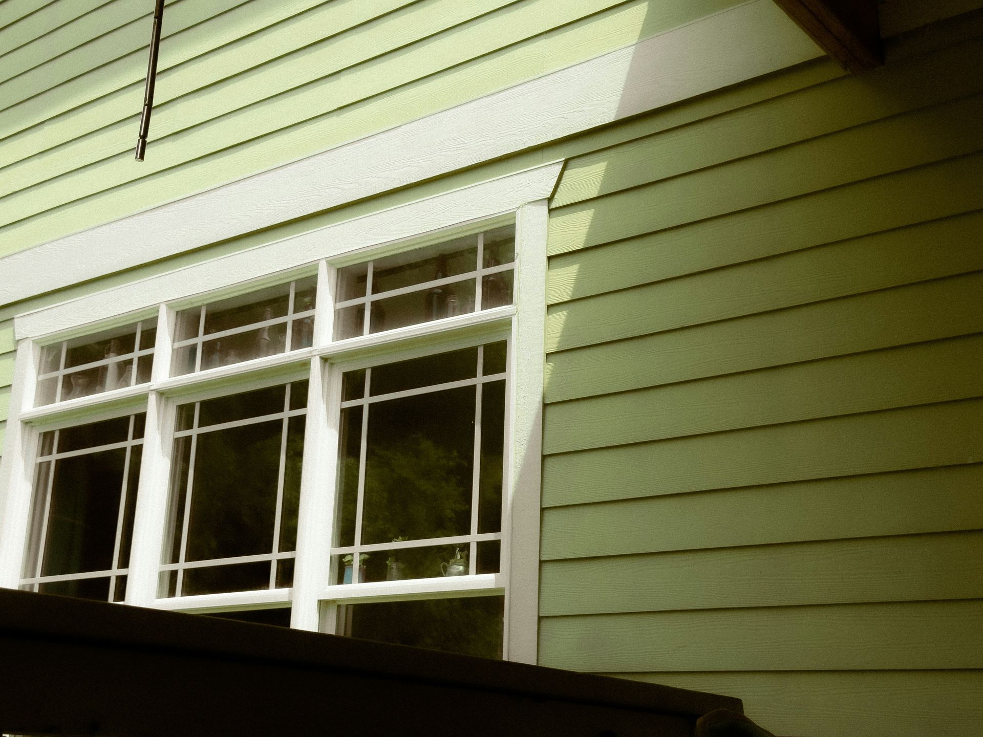 Window and siding of a green house.
